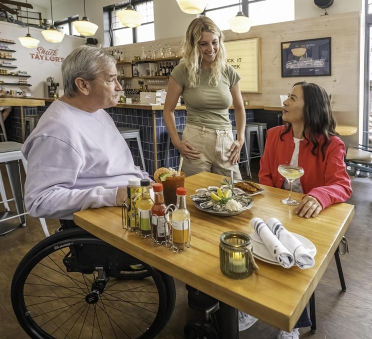 A couple enjoys oysters and cocktails at Shuck Taylor's, a seafood restaurant in Victoria, BC