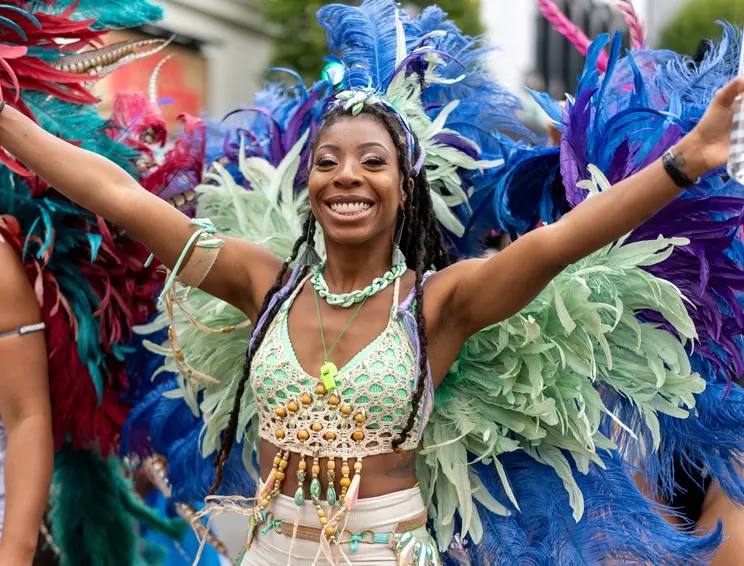 i-Land Fest Caribbean Carnival dancer Victoria BC wearing colourful feather costume at summer festival