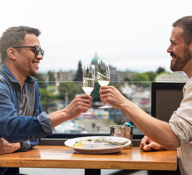A couple enjoys oysters and champagne on Finn's harbourfront patio.