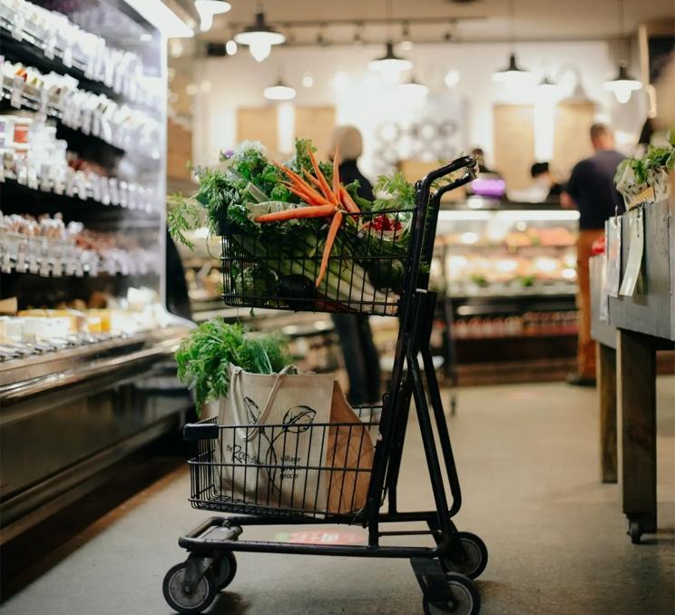 A grocery cart filled with vegetables at the Root Cellar Village Green Grocer in Victoria, BC