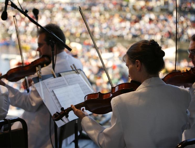 Victoria Symphony orchestra musicians performing live classical music at summer festival Victoria BC concert crowd