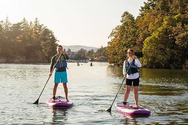 Two people paddleboarding on a lake