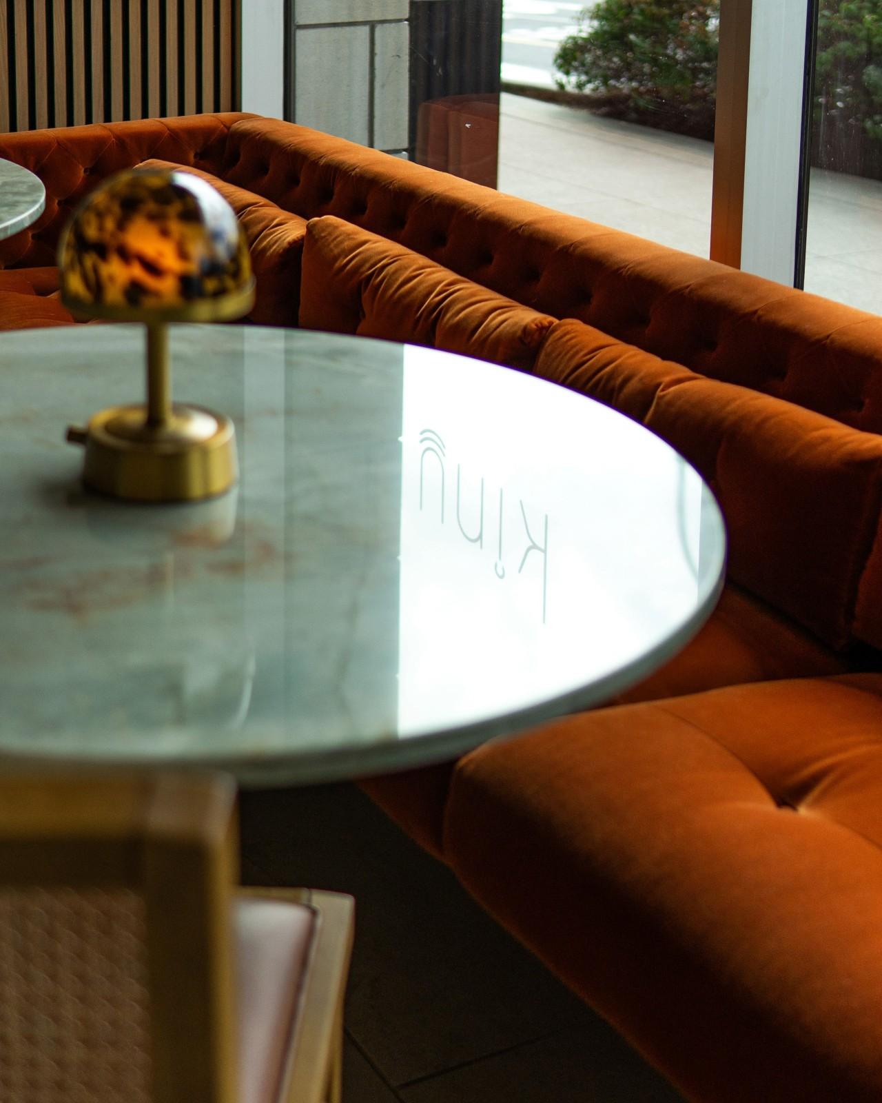 interior view of a window behind an orange sofa