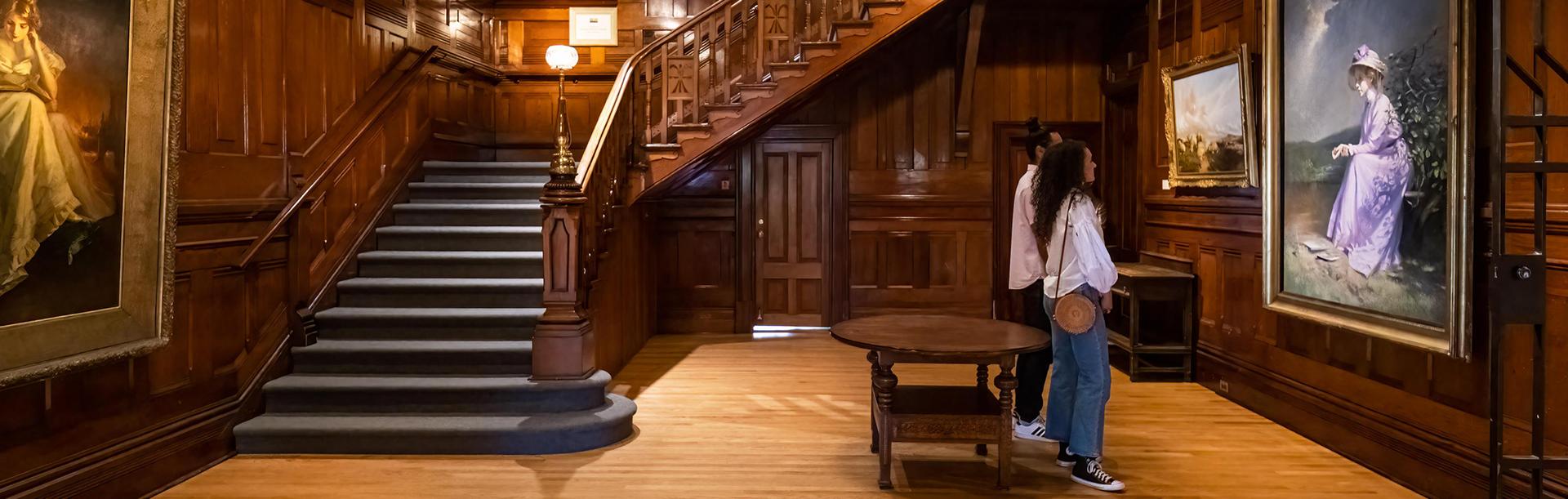 A couple examines artwork in the heritage home wing of the Art Gallery of Greater Victoria in Victoria, BC
