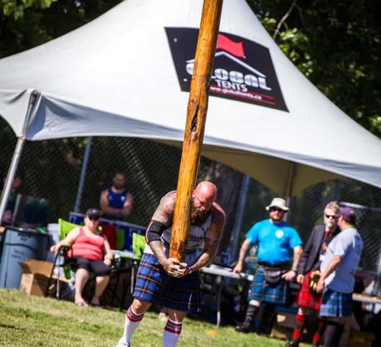 The Ironman and Highland Games with a man lifting a pole