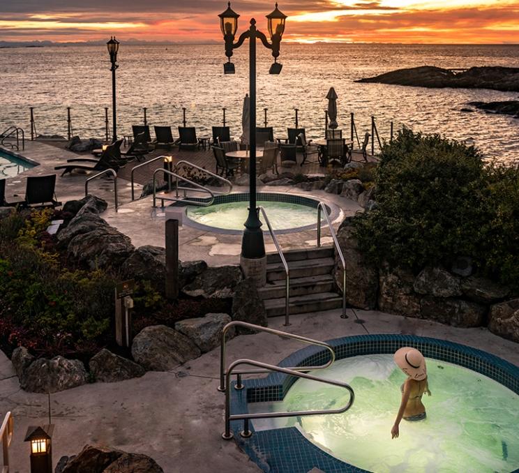 A woman soaks in the seaside mineral pools at the Oak Bay Beach Hotel in Victoria, BC