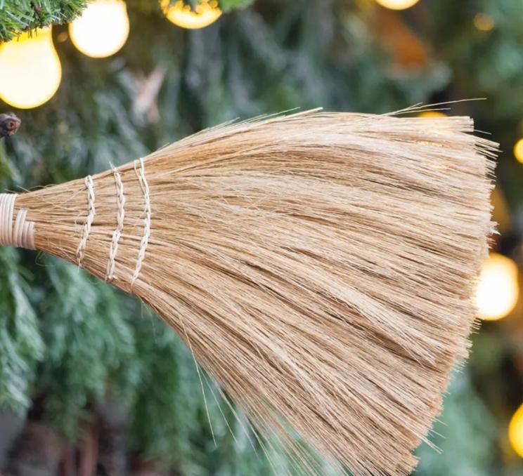 A broom in front of a Christmas backdrop