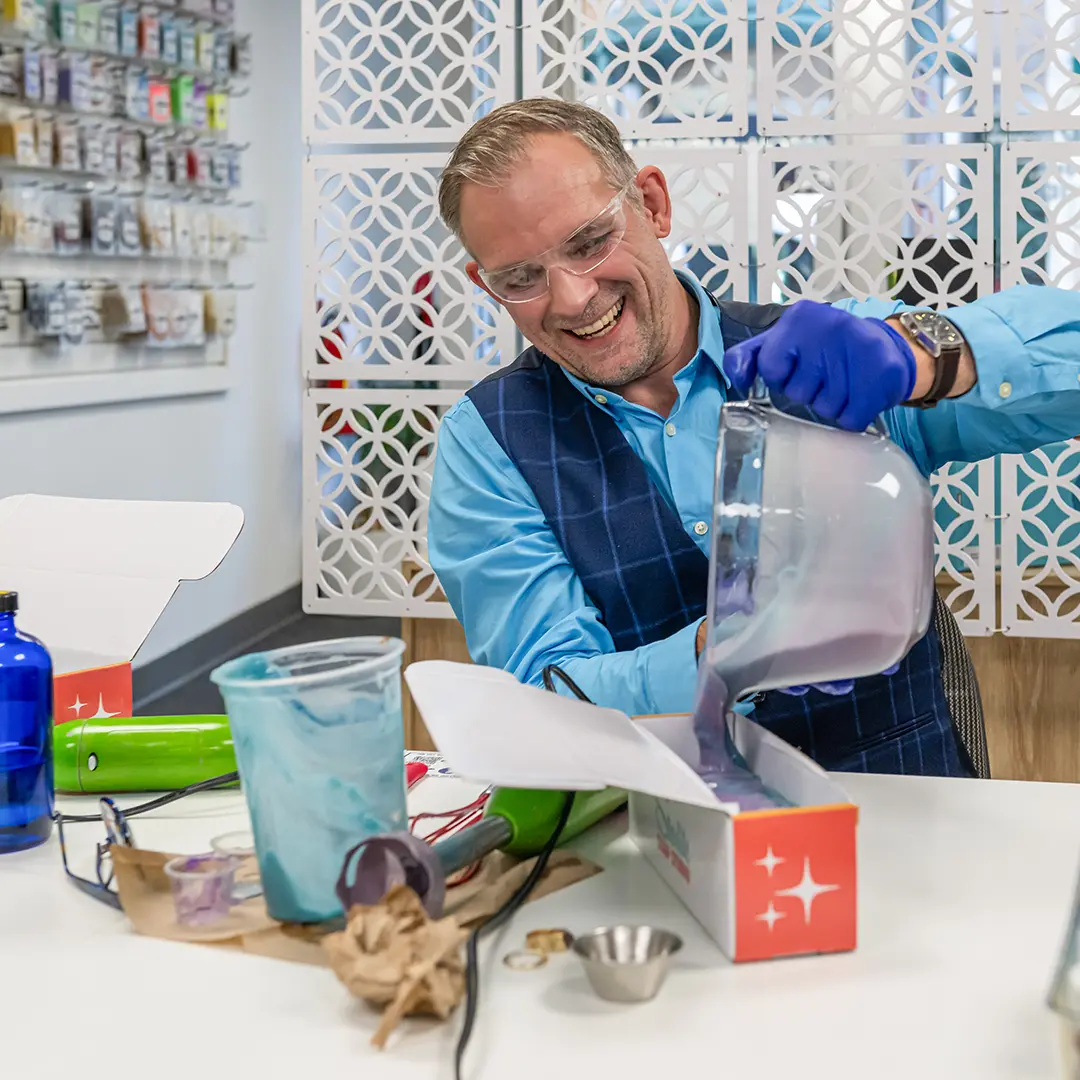 A man pours a soap creation from Starlite Soap Studio in Victoria, BC