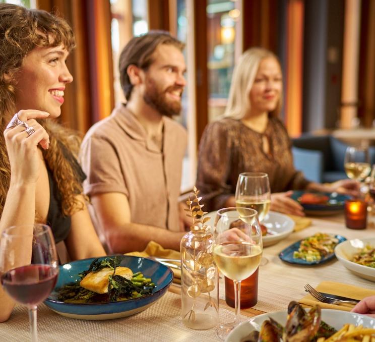 Friends enjoy a meal at the Arbutus Room in Victoria, BC