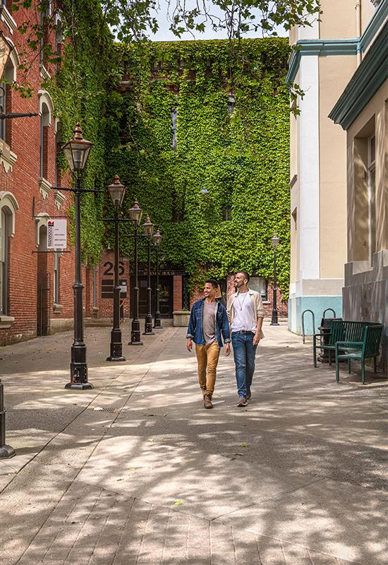 A couple walks through Bastion Square in Victoria, BC