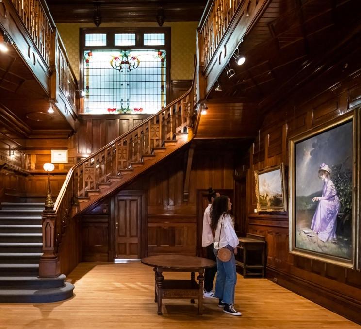 A young couple looks at a painting inside the Art Gallery of Greater Victoria in Victoria, BC