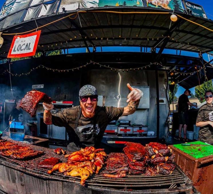 A ribber cooks ribs and chicken at Esquimalt Ribfest in Victoria, BC