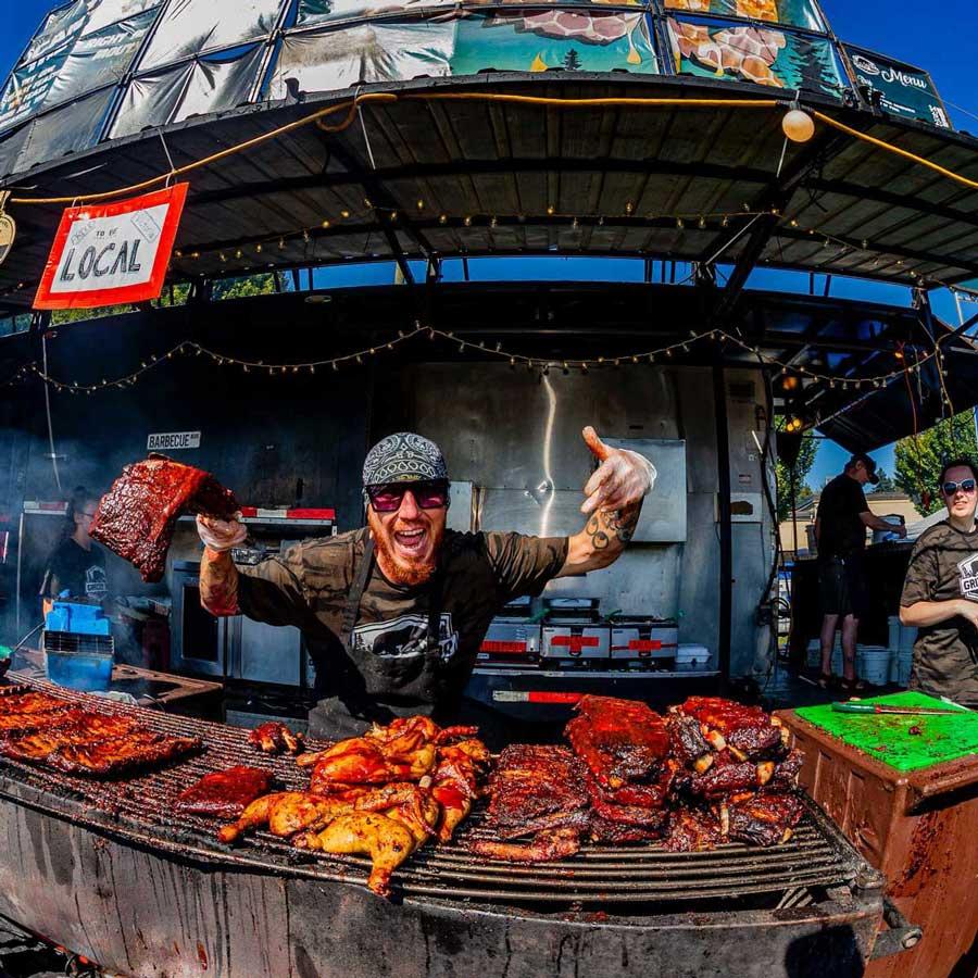 A ribber cooks ribs and chicken at Esquimalt Ribfest in Victoria, BC