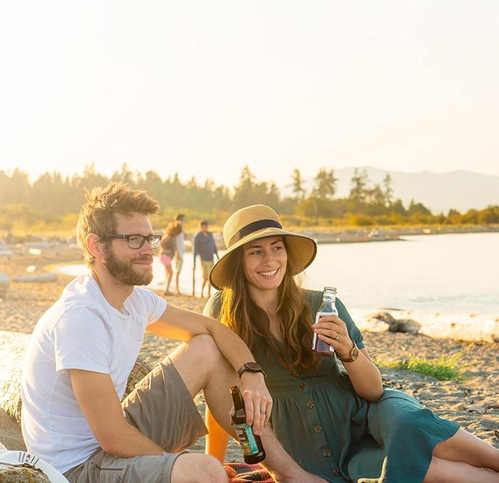 A couple enjoys a picnic on the beach in Victoria, BC