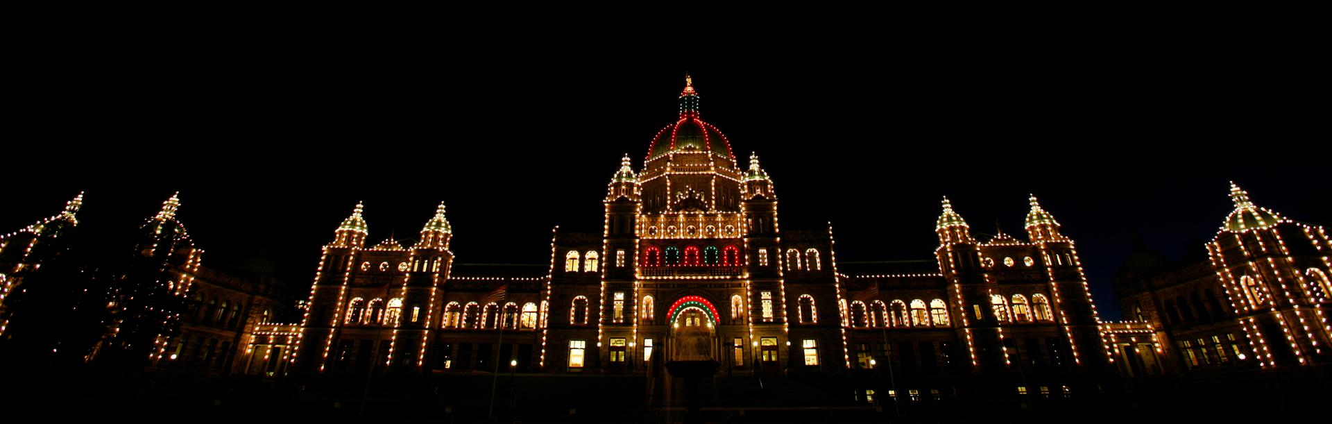 The BC Parliament Buildings illuminated at night during the holiday season in Victoria, BC