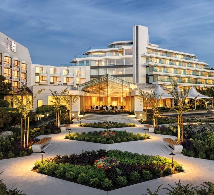 The exterior of Inn at Laurel Point garden in the evening.