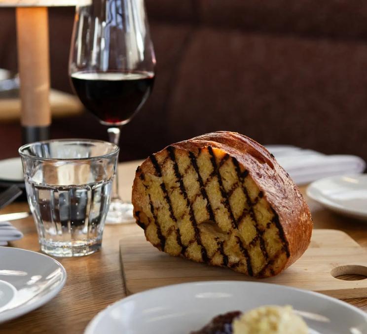 Bread, wine, and butter are served at Rudi in Greater Victoria, BC