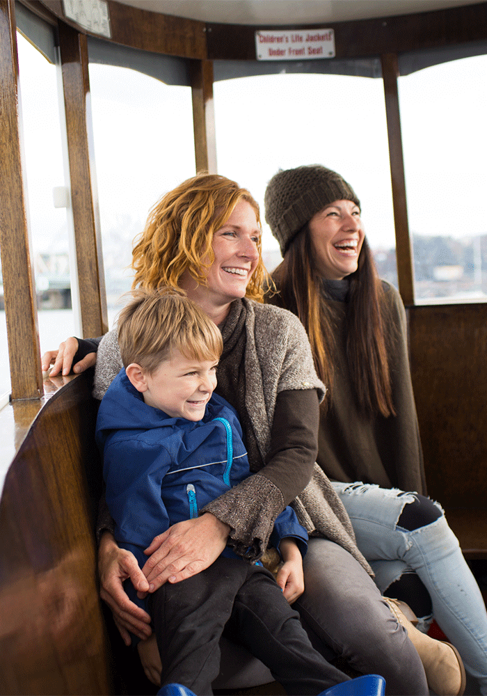 A family sits aboard a Harbour Ferry in Victoria, BC