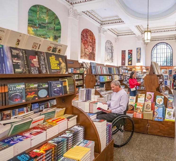 A couple shopping for books inside Munro's Books on Government Street in Victoria, BC