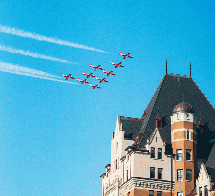 The Snowbirds, a Canadian aerial demonstration squad flies their signature red aircraft above the Fairmont Empress.
