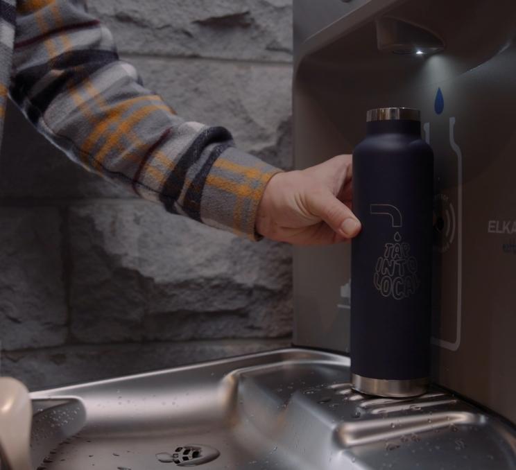 A person fills their Tap into Local water bottle at the Parkside Hotel & Spa's water bottle refill station in Victoria, BC