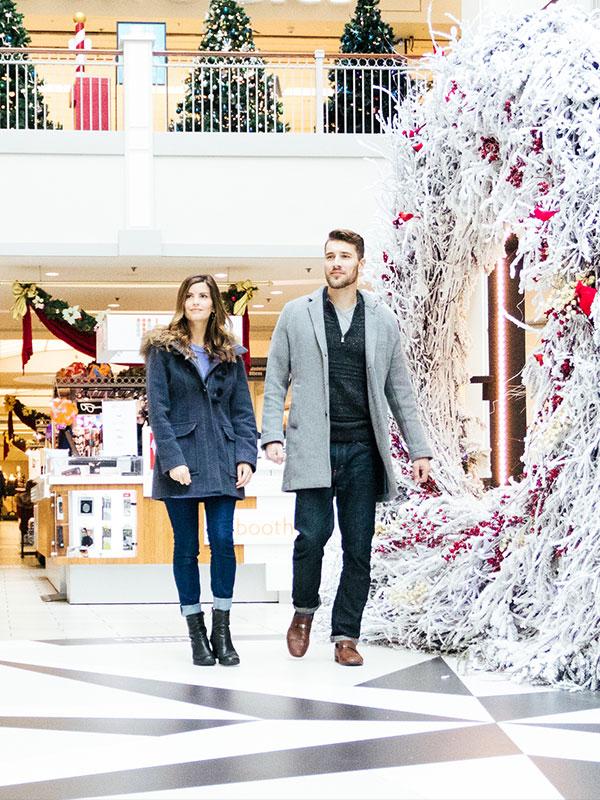 A couple walks through a Christmas display at the Bay Centre Shopping Centre in downtown Victoria, BC