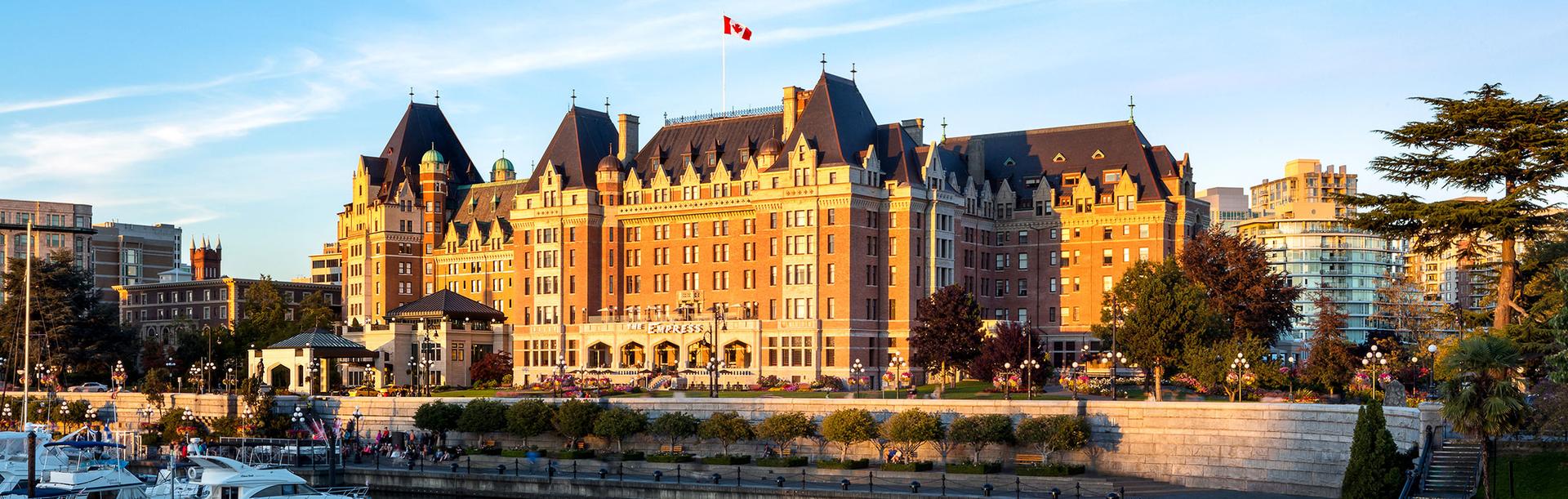 The Fairmont Empress hotel on Victoria, BC's Inner Harbour illuminated by morning sunlight