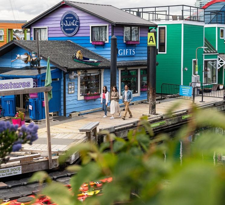 A family walks along the docks at Fisherman's Wharf in Victoria, BC's James Bay neighbourhood