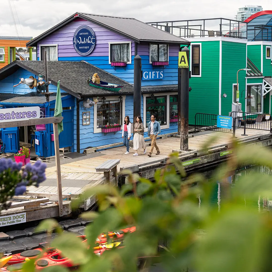 A family walks along the docks at Fisherman's Wharf in Victoria, BC's James Bay neighbourhood
