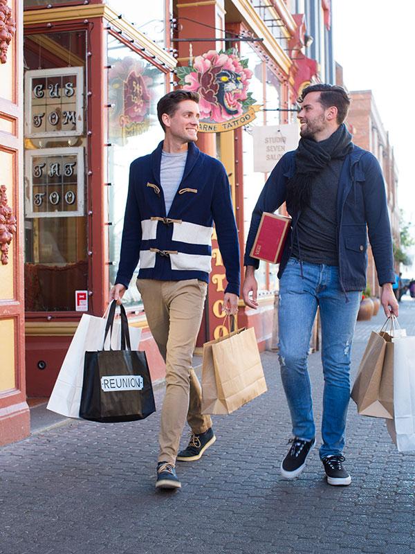 A male couple enjoys some shopping along Lower Johnson Street in Victoria, BC