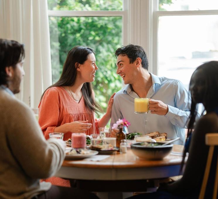 A group of friends enjoy brunch and lattes in at Nourish Kitchen & Cafe in Victoria, BC
