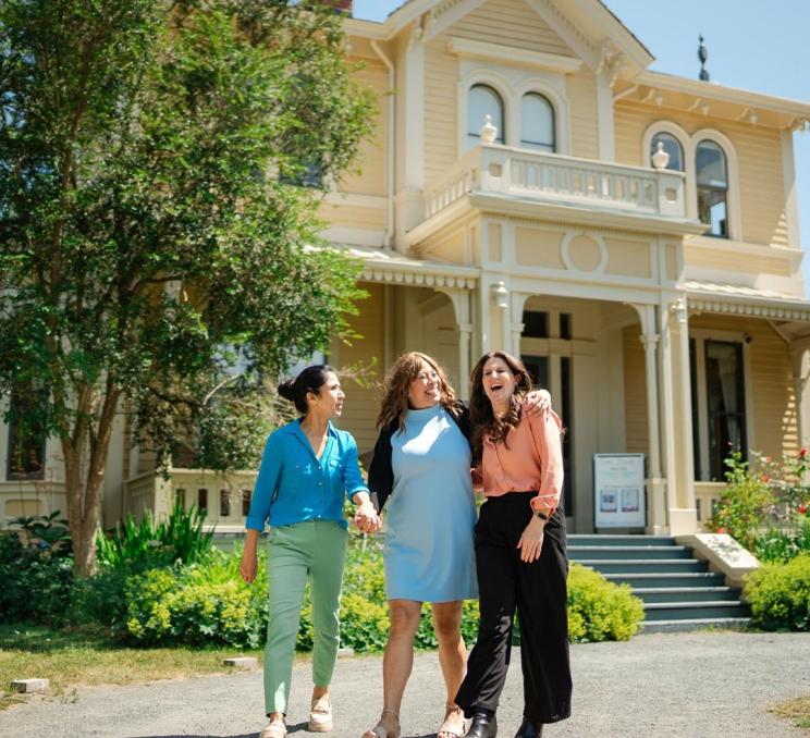A group of friends walking outside of Emily Carr House in Victoria, BC