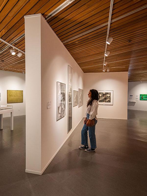 A woman examines the artwork at the Art Gallery of Greater Victoria in Victoria, BC