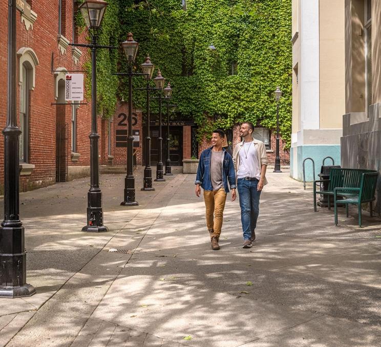 A couple walks through Bastion Square in Victoria, BC