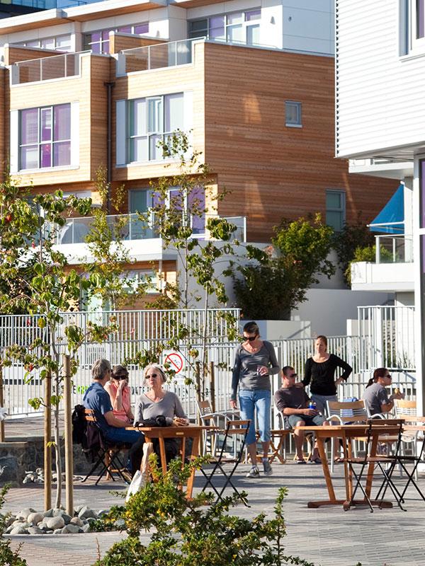 People dining on the patio at Caffe Fantastico in Dockside Green in Victoria, BC's Vic West neighbourhood