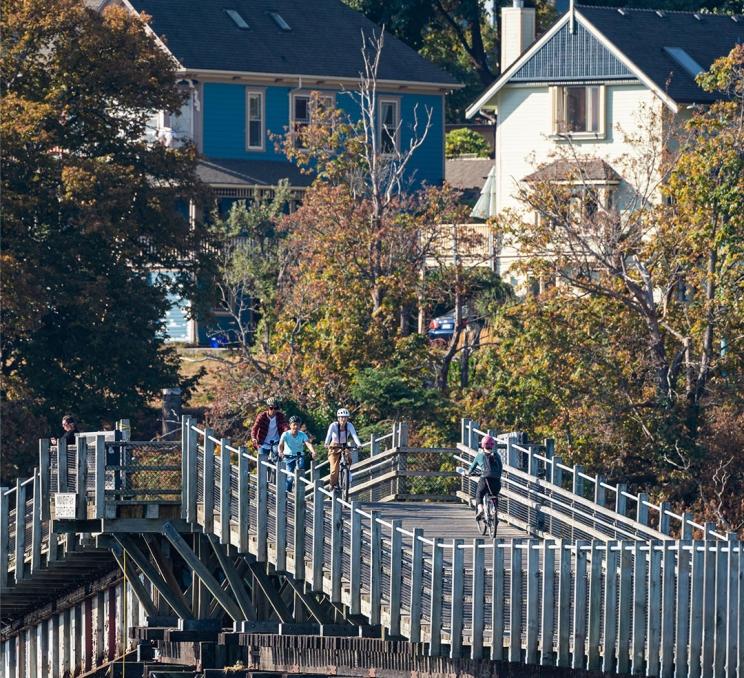 A group of cyclists passing over the Selkirk Trestle in Victoria, BC's Vic West neighbourhood