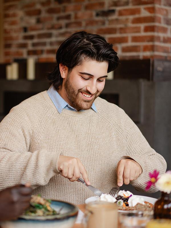 A person tucks into their plant-forward meal at Nourish Kitchen & Cafe in Victoria, BC