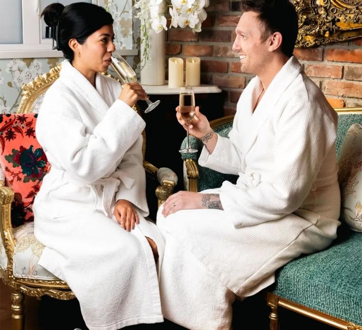 A couple drinks champagne in robes at Salt & Ivy Spa at the Rosemead House hotel in Victoria, BC