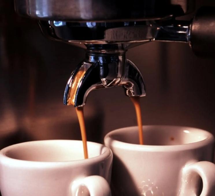 An espresso machine fills to coffee cups at the Courtyard Cafe in Victoria, BC