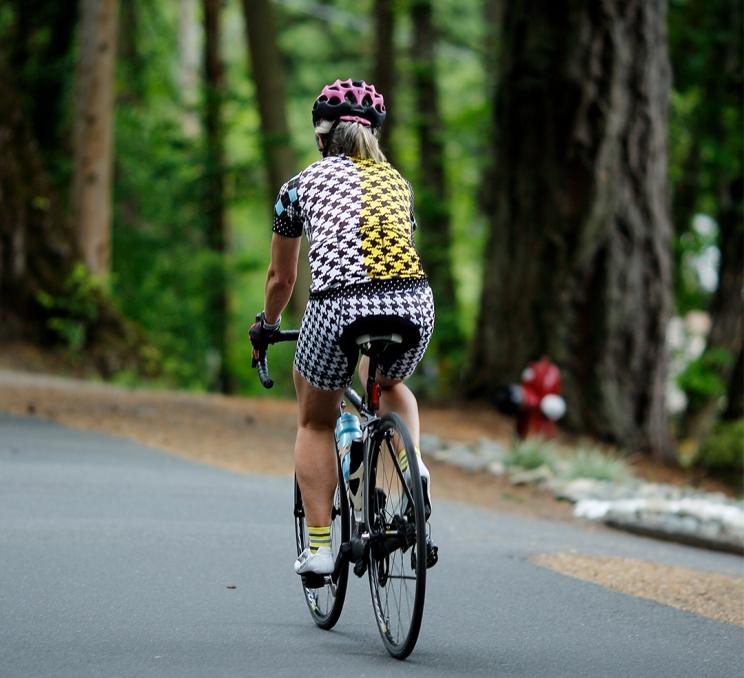 A cyclist rides their bike down the Lochside Regional Trail in Saanich, BC