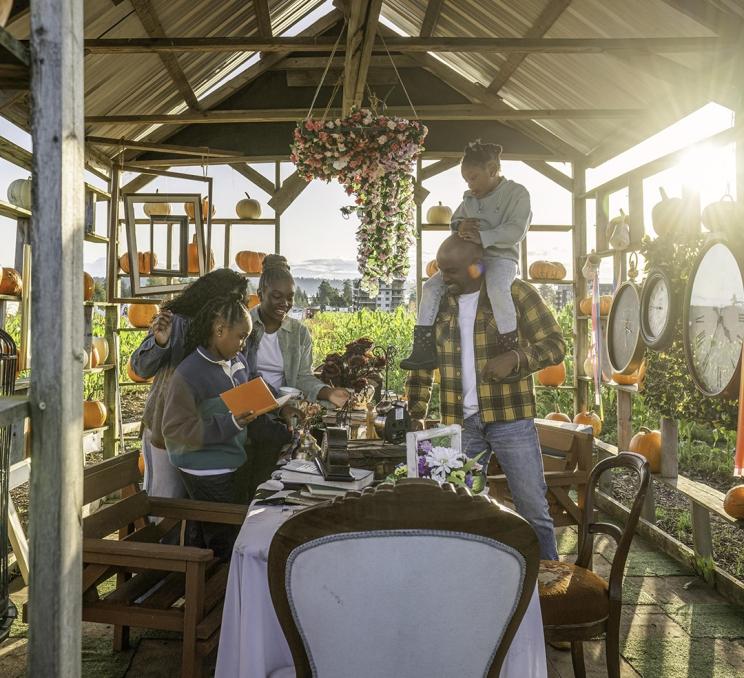 A family explores an a decorative display in a pumpkin patch at Ocean View Estates in Victoria, BC