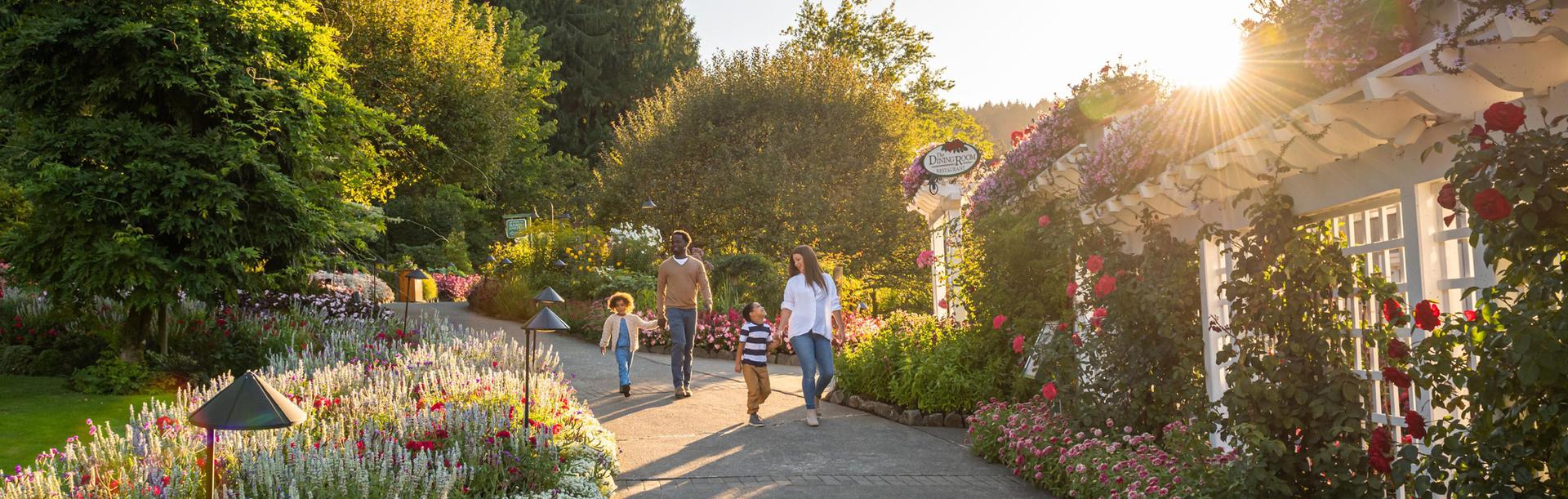 Family walking through The Butchart Gardens in the evening