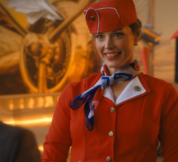 A cast member from the hit Netflix show Crew Girl attends a party dressed as a flight attendant at the BC Aviation Museum