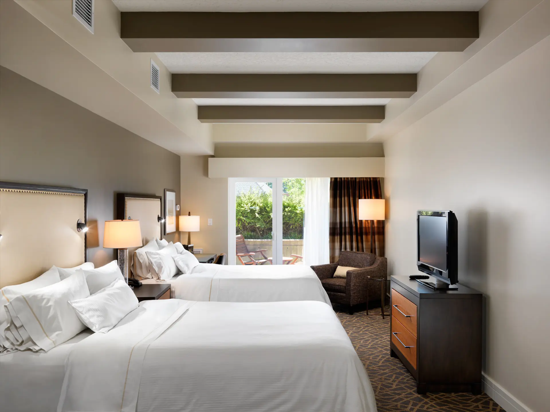Two queen beds with kitchenette and patio