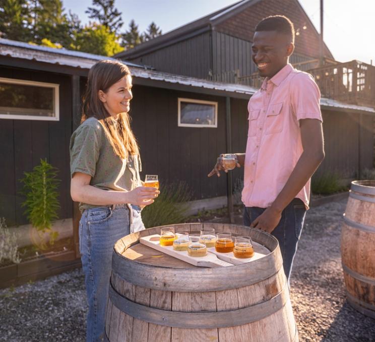 A couple having a cider flight at Junction Orchards in Victoria, BC