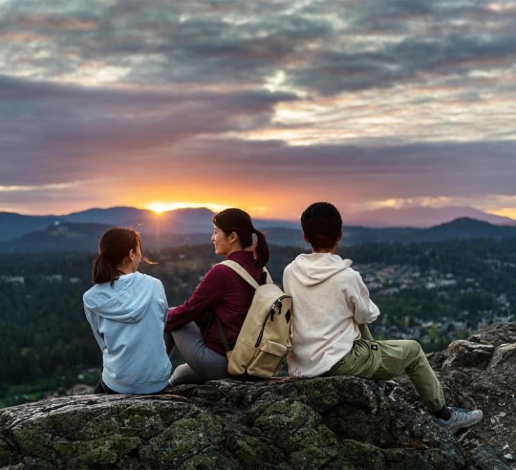 Family on PKOLs mountain watching the sunset in Victoria, BC
