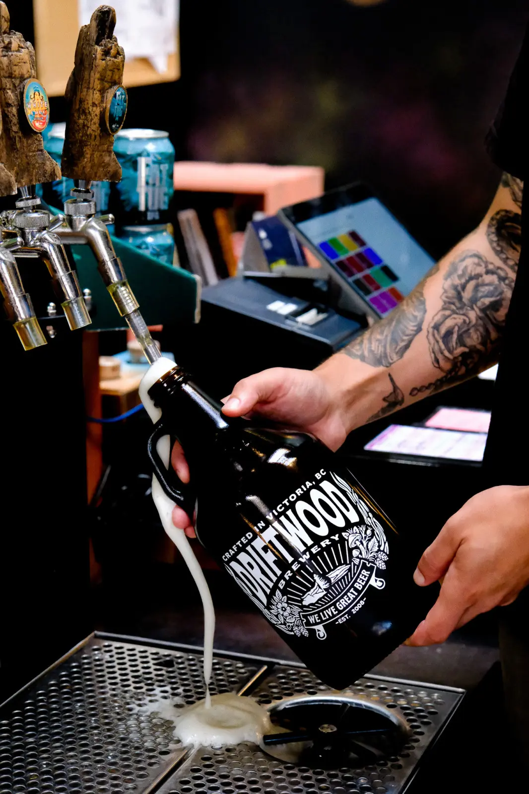 A Driftwood Brewery growler being filled with beer