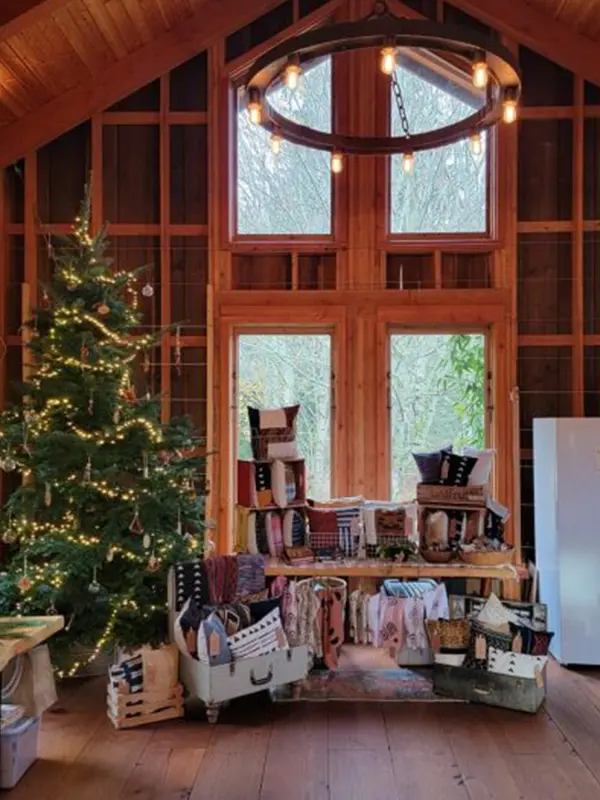The interior of the barn at Bilston Creek Farm's annual Yuletide Market Series shows holiday displays and Christmas tree
