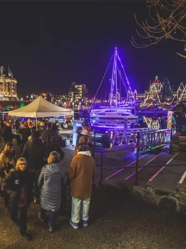 A crowd explores the lower causeway of the Inner Harbour during the Greater Victoria Harbour Authority's Harbour Light Up, a Christmas season event in Victoria, BC