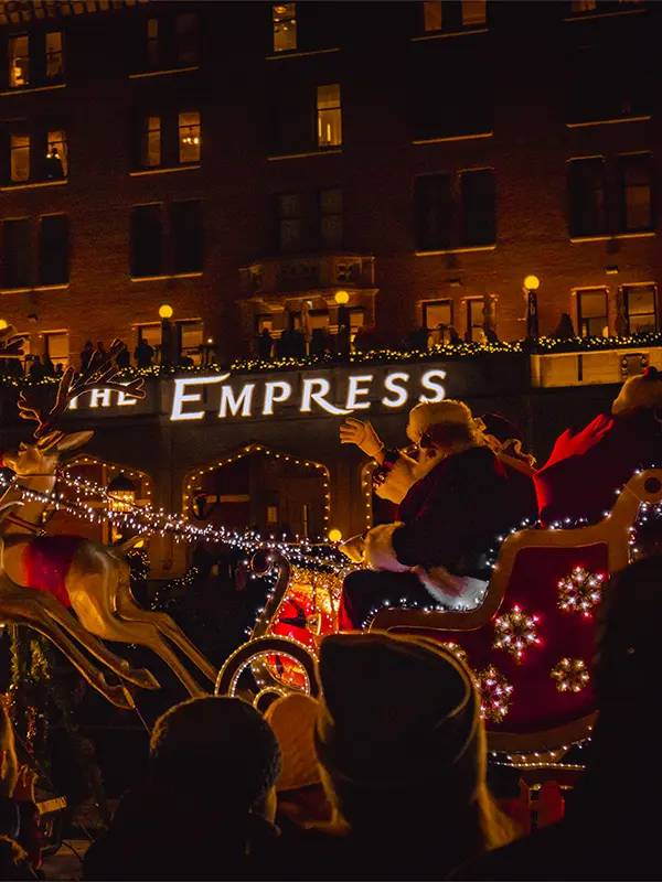 Santa Claus waves to the crowd as he passes the Fairmont Empress during the Santa Claus Parade in Victoria, BC